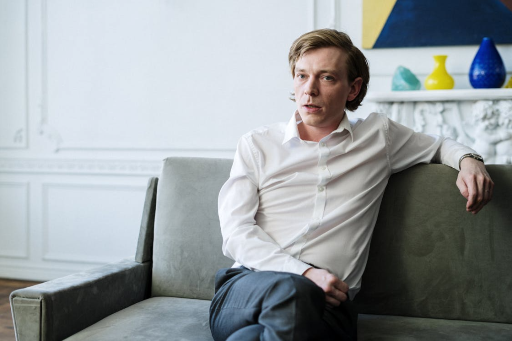 An image of a man sitting on a couch  