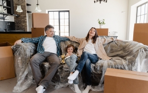 Father, son and mother sitting on a couch relaxed