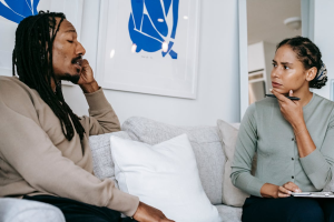An image of a man talking to a therapist