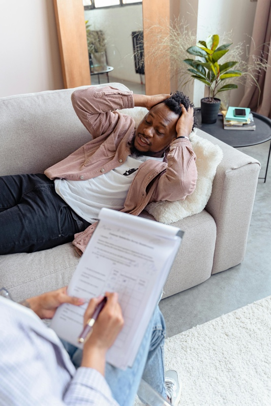 Woman looking toward a stressed man seated beside her.