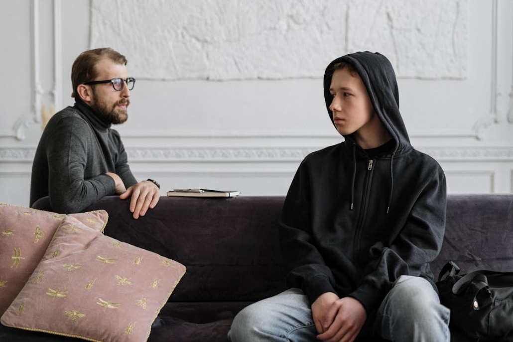  A small group of men participating in a guided therapy session, discussing their experiences with sexual addiction.