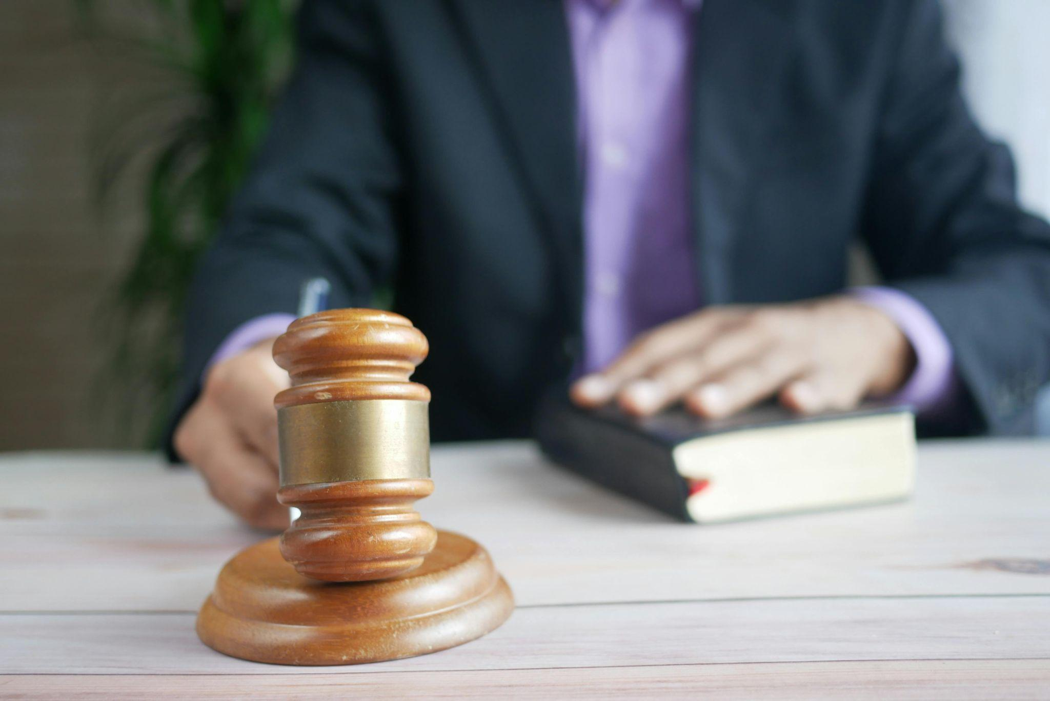 This photo shows a person holding a gavel.