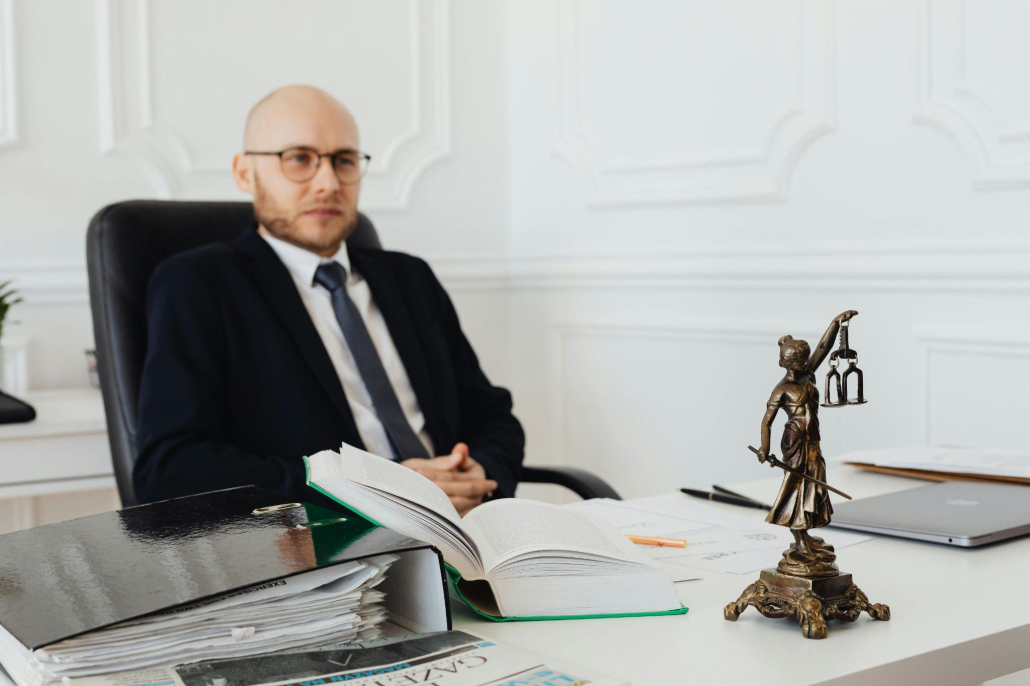 bald-man-sitting-wearing-eyeglasses-and-black-suit