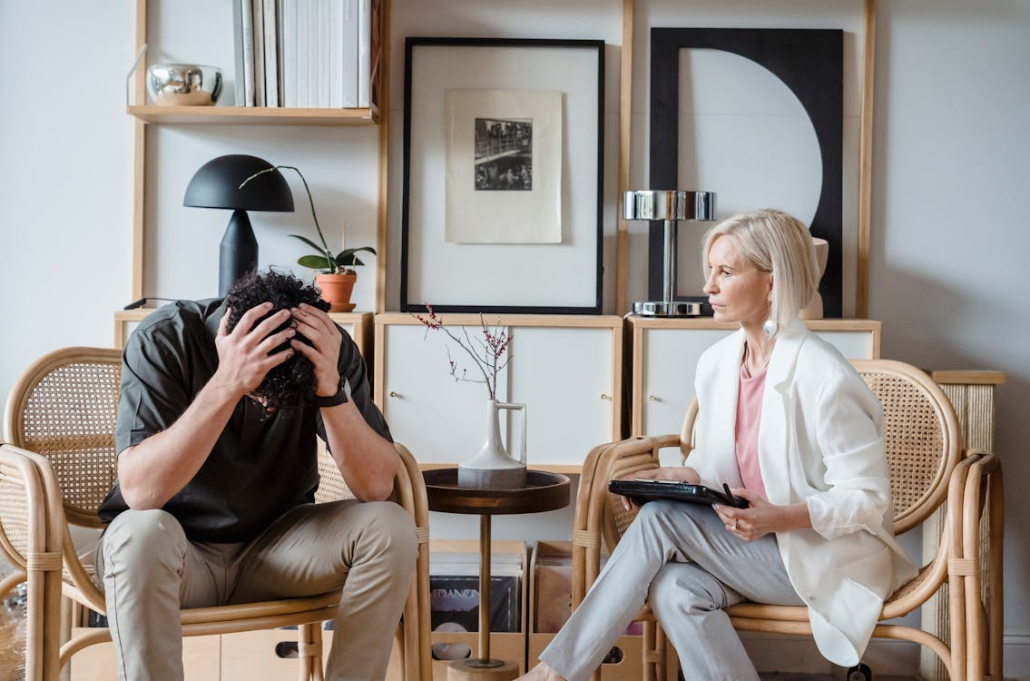 a woman counselling a stressed man