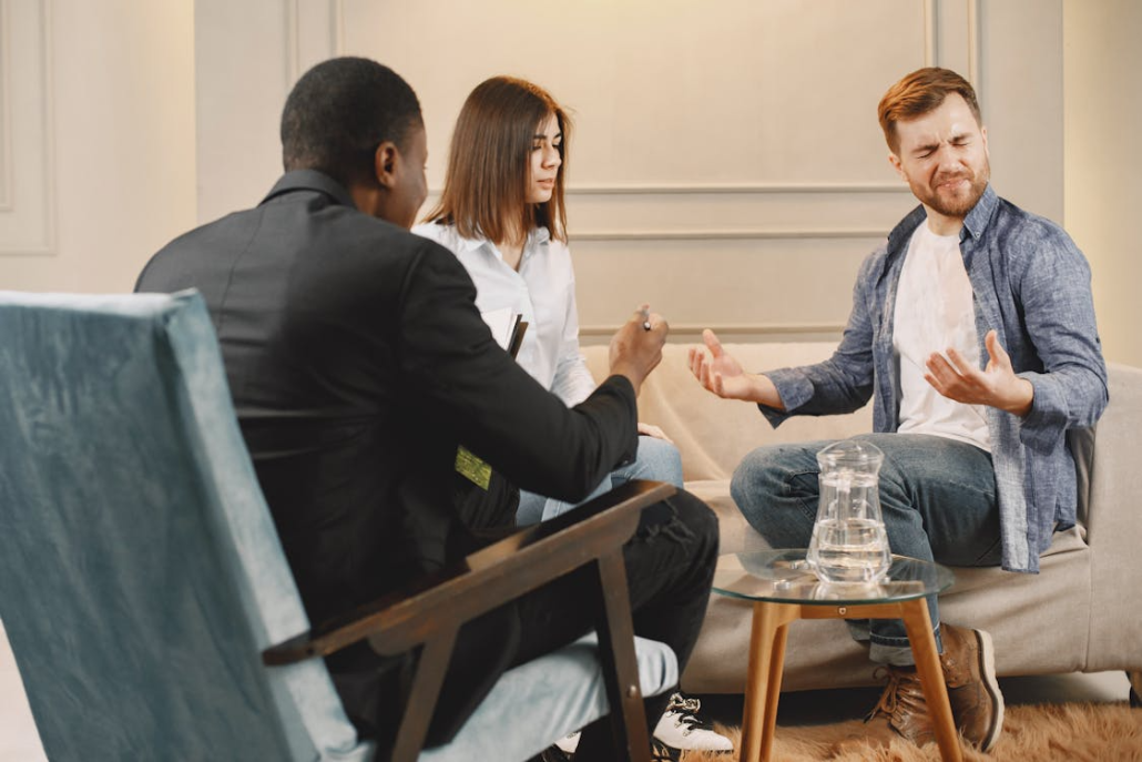 a man and woman sitting in therapy